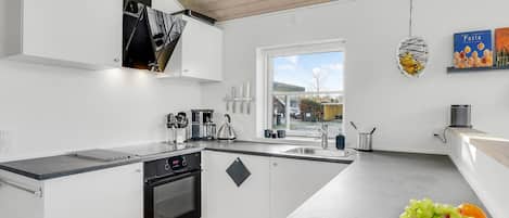 Fridge, stovetop, dishwasher, coffee/tea maker