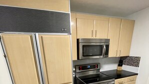 A kitchen with beige cabinets, a stainless steel refrigerator, a microwave, and a double oven. - Blocks Aways From Brickell Village, 2 beds 2 Baths FREE Parking NO Cleaning FEES (Miami)