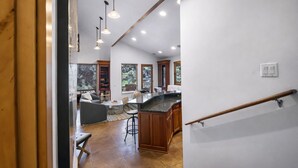 A modern kitchen with a marble countertop, wooden cabinets, and pendant lighting. - 502 A Gold Coast! 3 Bedroom Townhouse by RedAwning (Park City)