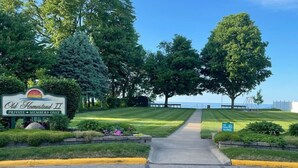 A private members-only entrance to Old Homestead II with a clear pathway leading to a beach view.