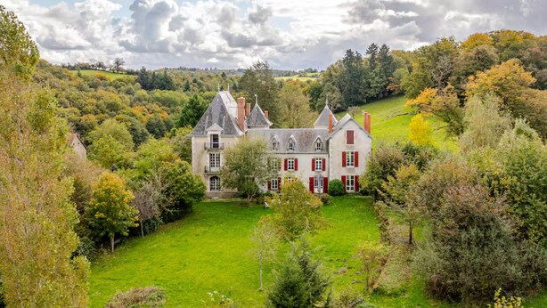 A large, historic building with multiple chimneys, surrounded by lush greenery and trees. - Chateau / Country House (La Celle)