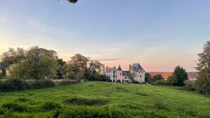 A large, historic building with multiple towers and a well-maintained lawn in the foreground. - Chateau / Country House (La Celle)
