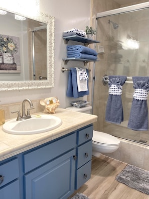 Combined shower/tub, hair dryer, towels, soap