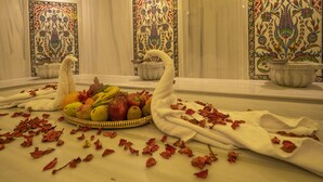 A luxurious bathroom with a marble floor, a large mirror, and ornate tile walls. - Balsoy Mountain (Erzurum)