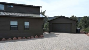 A two-story building with a paved driveway and a garage.