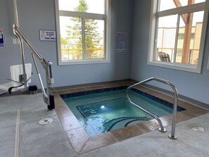 A pool area with a no glass allowed sign, a spa rules sign, and a pool ladder. - Sugar Ski Two Bedroom - Unit 515 (Sugar Mountain)