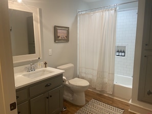 Combined shower/bathtub, towels, soap, toilet paper