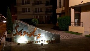 A stone sign with the name 'Sunk2' and 'HOLIDAY APARTMENTS' indicating a holiday apartment complex. - Stylish 1-bed Apartment in Sunny Beach (Sunny Beach)