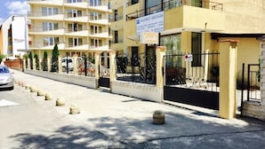 A multi-story building with a sign for 'Property Services' and 'Orange'. - Stylish 1-bed Apartment in Sunny Beach (Sunny Beach)