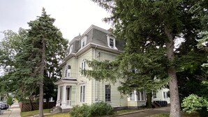 A two-story house with a front porch and a garage. - 1 Bedroom Studio and 1 Full Bathroom-Close to Beach, Encore and TD Garden Arena. (Chelsea)