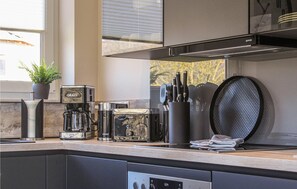 Fridge, stovetop, dishwasher, coffee/tea maker