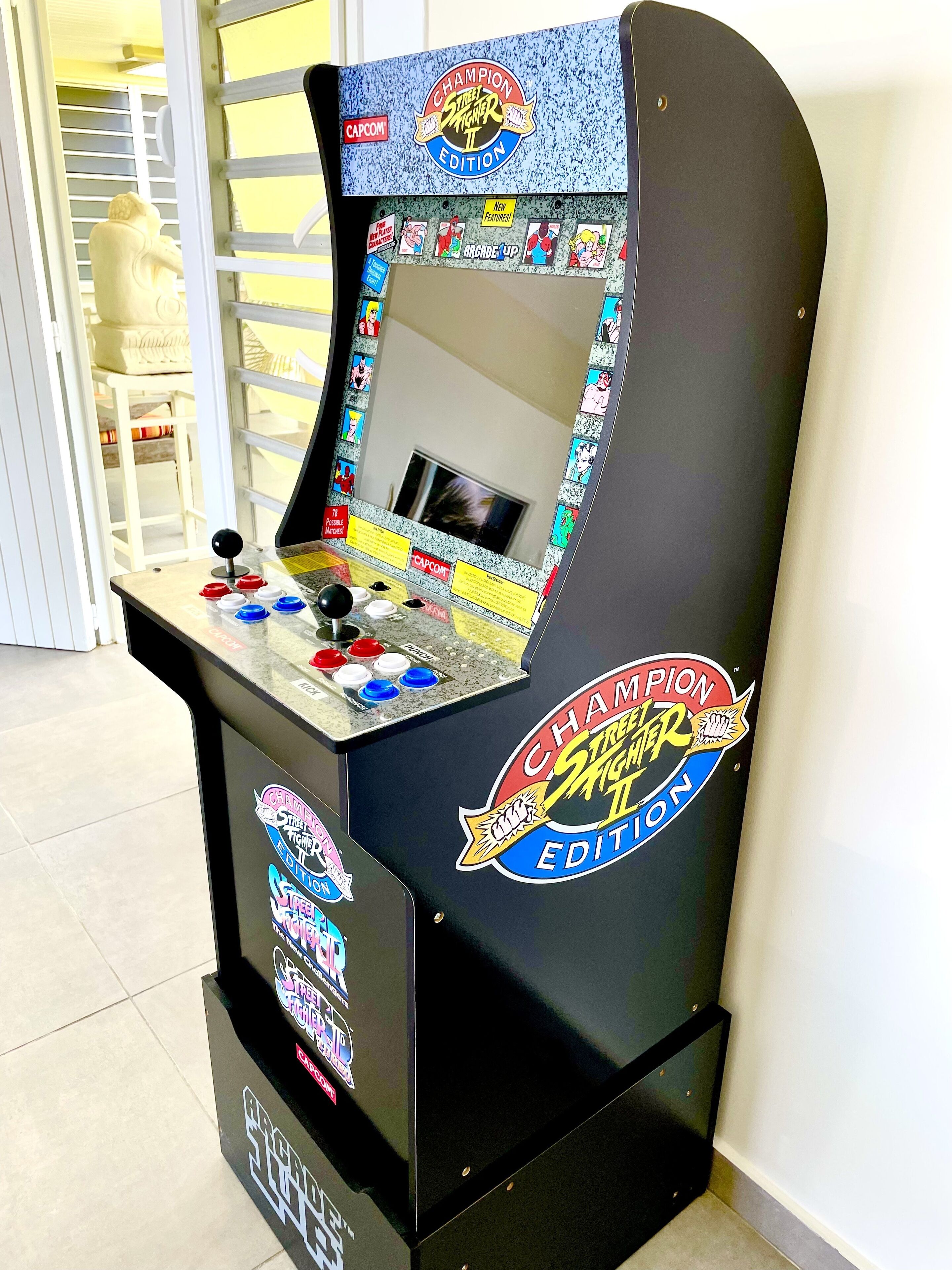 A retro arcade machine labeled "Champion Street Fighter II Edition" with a joystick, buttons, and a screen.