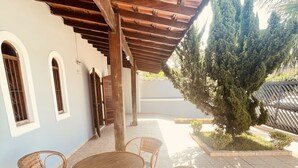 A covered patio with wicker furniture and a tiled floor. - Vacation home in Peruíbe (Peruibe)