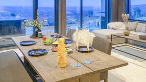 A dining area with a table set for four, overlooking a snowy landscape. - Awesome home in Hønefoss with WiFi (Hønefoss)