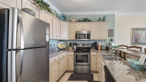 Enjoy meals in the kitchen with a dining area offering a city view.