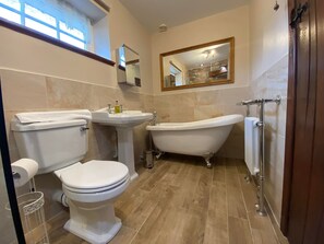 Bathtub, towels, soap, toilet paper