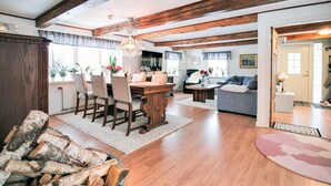 A spacious living area with a wooden dining table, chairs, and a sofa. - Pet friendly home in Perstorp with WiFi (Perstorp)