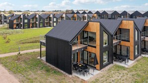 A modern residential complex with multiple two-story houses featuring large windows, balconies, and a flat roof design. - Amazing apartment in Slagelse (Slagelse)