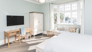A bedroom with a bed, a desk, a wardrobe, and a TV. - Cedar House (Gisborne)