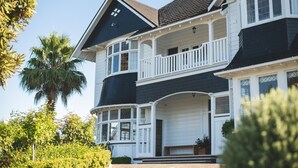 A two-story house with a balcony and a garage. - Cedar House (Gisborne)