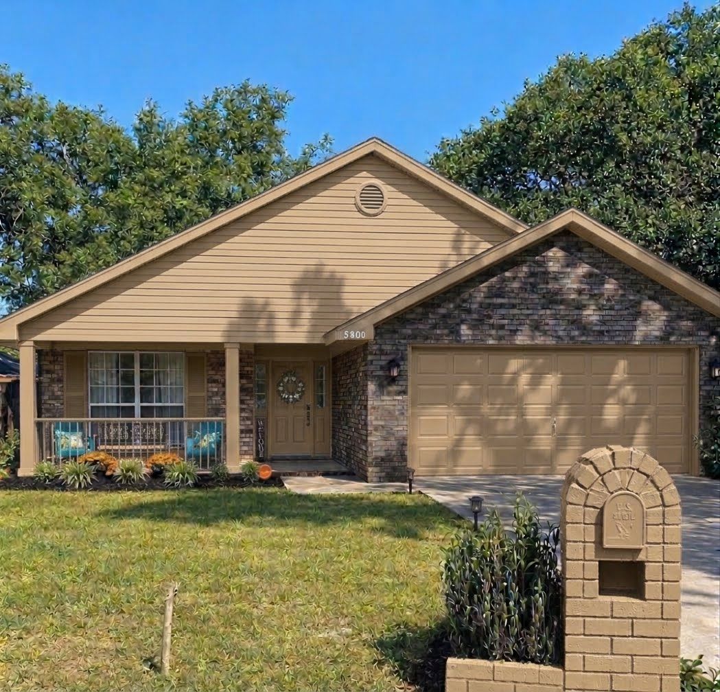 Een gelijkvloers huis met een veranda, een garage en een brievenbus.