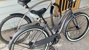 A bicycle parked outside a house with a wooden door and a window. - Chic cottage, Vamo area, close to beaches, pet friendly, kayaks, large backyard  (Sarasota)