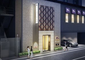 A modern hotel entrance with a patterned facade, a visible elevator, and a parked car. - Hotel Monte Hermana Tokyo (Tokyo)