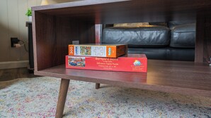 A wooden coffee table with a jigsaw puzzle box on it. - Vacation UniquEly home in town, with patio (Ely)