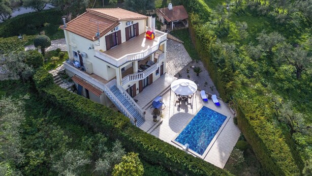 A two-story house with a swimming pool, a covered patio, and a well-maintained garden. - Villa Napolia - Luxury Villa With Amazing Sea View (Zakynthos)