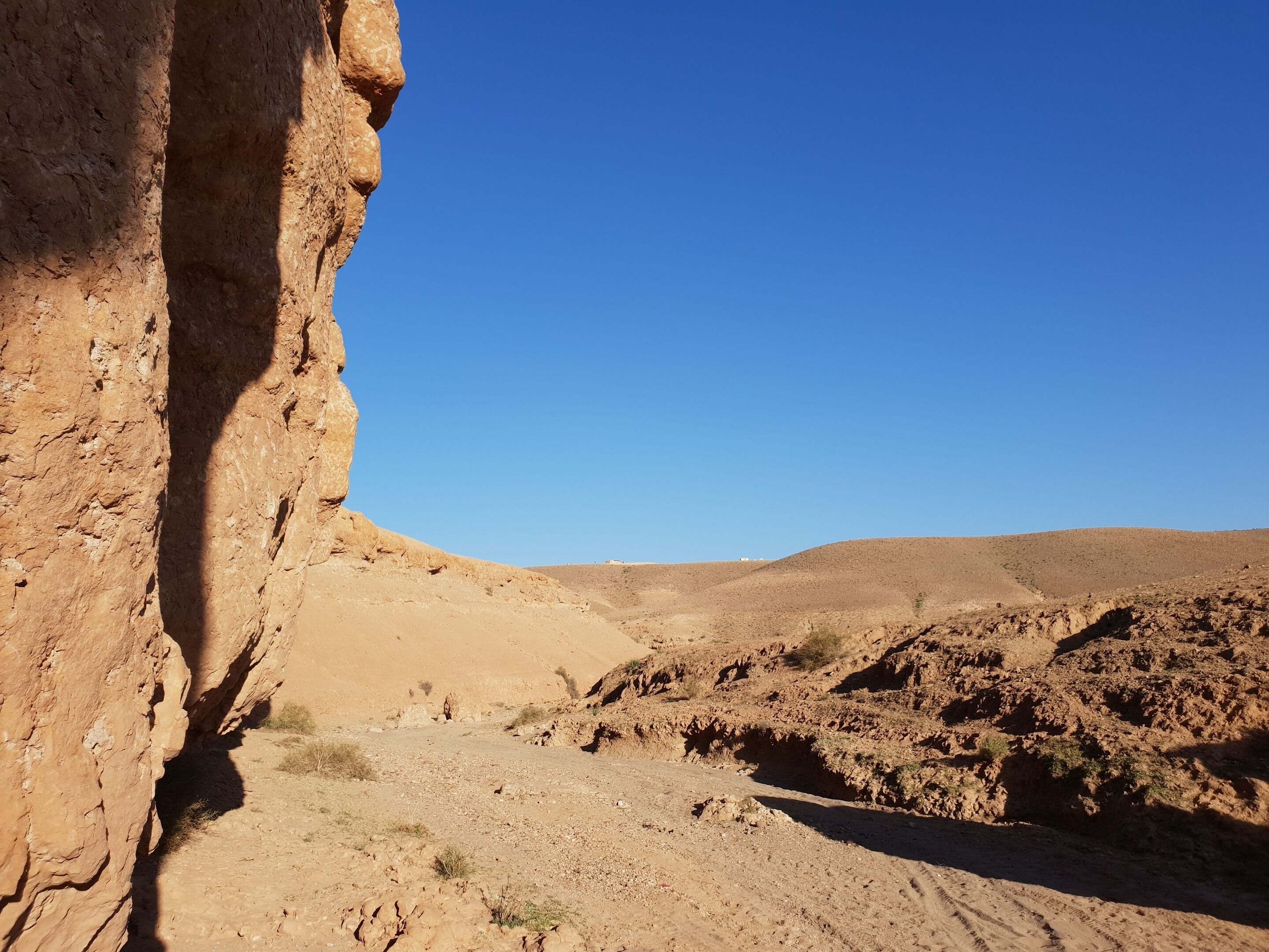 A rocky desert landscape with a clear sky.