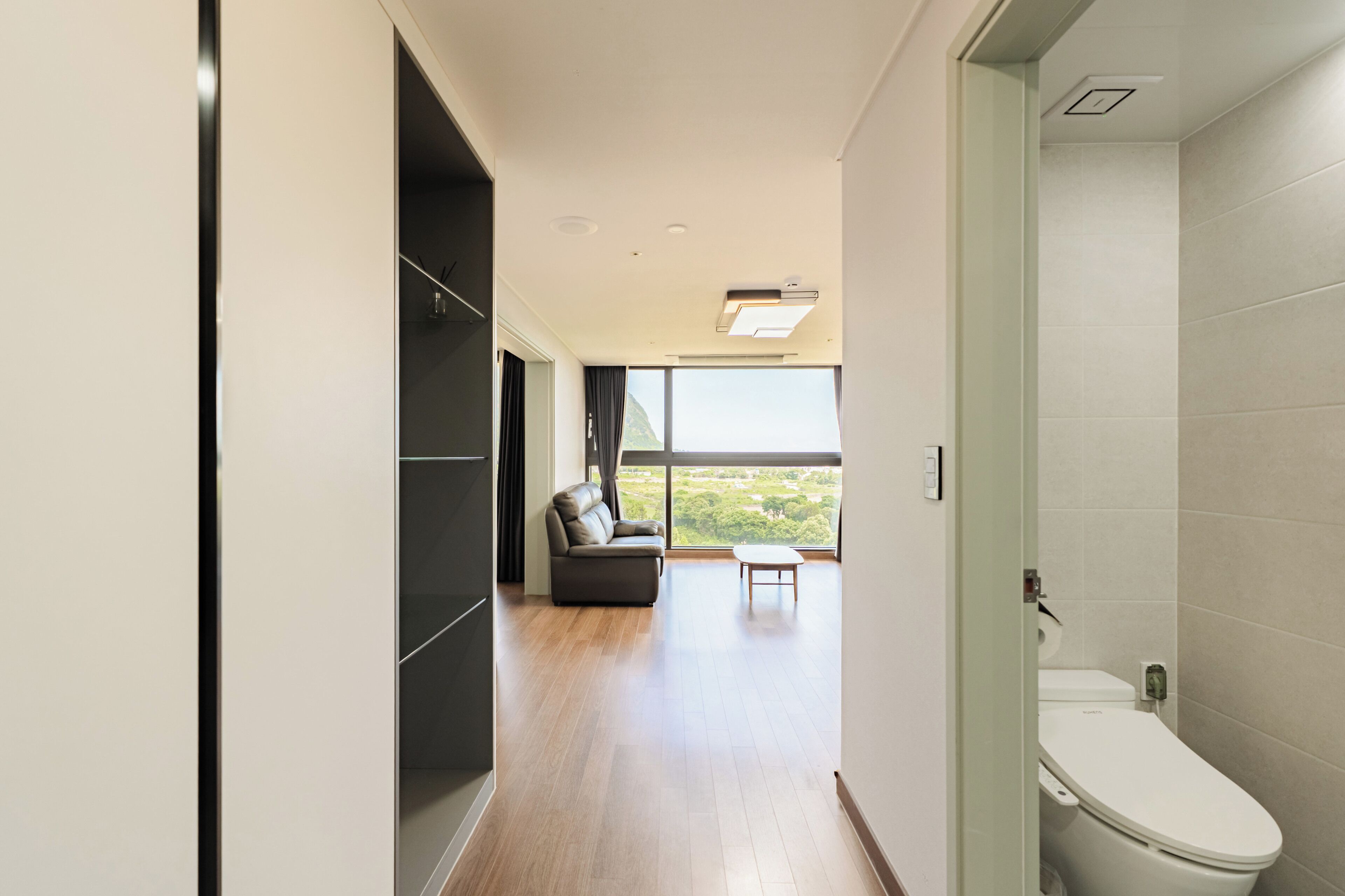 A modern bathroom with a toilet and a shower area.