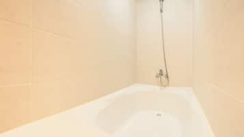 A bathroom with a bathtub, a shower, and tiled walls.