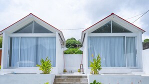 A modern two-story house with a staircase leading to the entrance. - Jempana View (Kintamani)