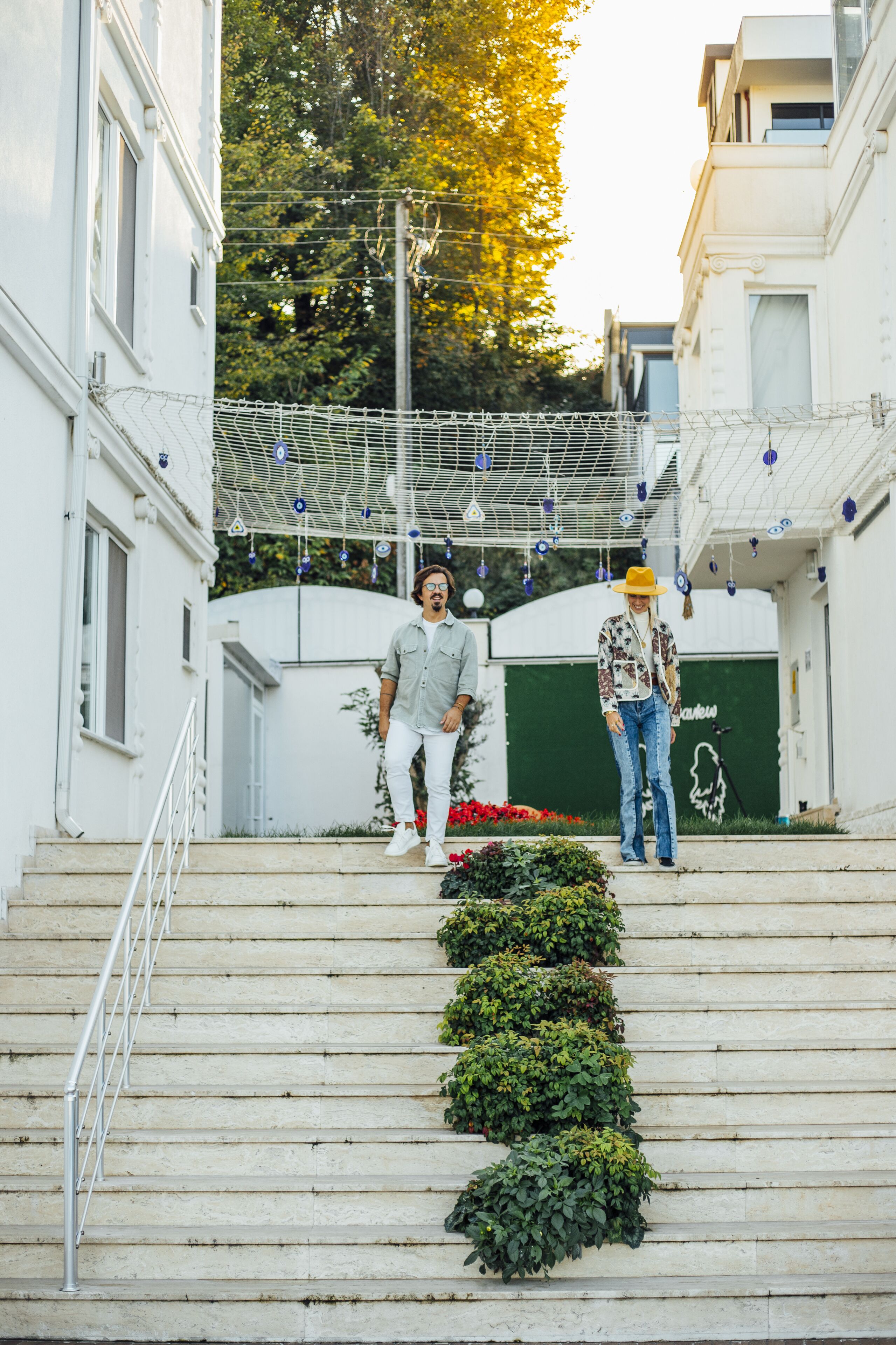 A staircase leading up to a building with white walls and a green door.