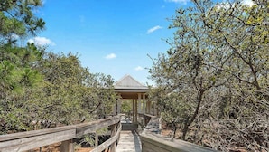 A wooden boardwalk leading to a gazebo in a natural setting with trees and shrubs. - Lite House II at Martinique - Golf Cart Included - Just steps to the beach!!! (Fort Morgan)