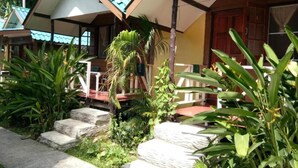 A building with a sloped roof and a porch area with steps leading up to it. - X-BAR and Bungalow (Trat)