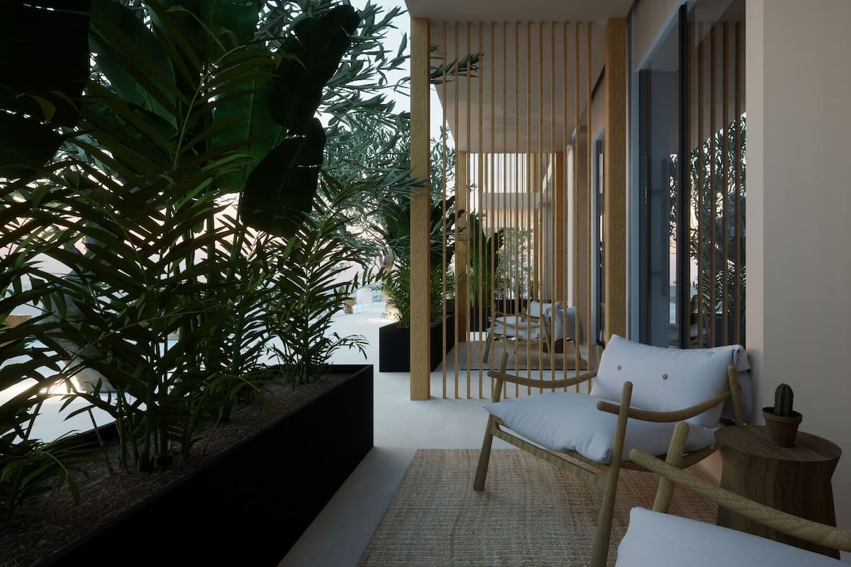 A modern outdoor seating area with a wooden chair and a small table, surrounded by lush greenery and a wooden fence.