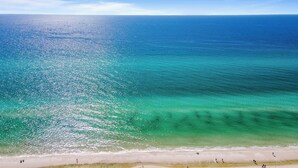 A beach with clear turquoise water and a sandy shore. - 2BR/2BA, Amazing Gulf/Pool Views! Shores of Panama (Panama City Beach)