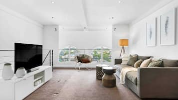 Basic Apartment, Multiple Beds | Living room | TV