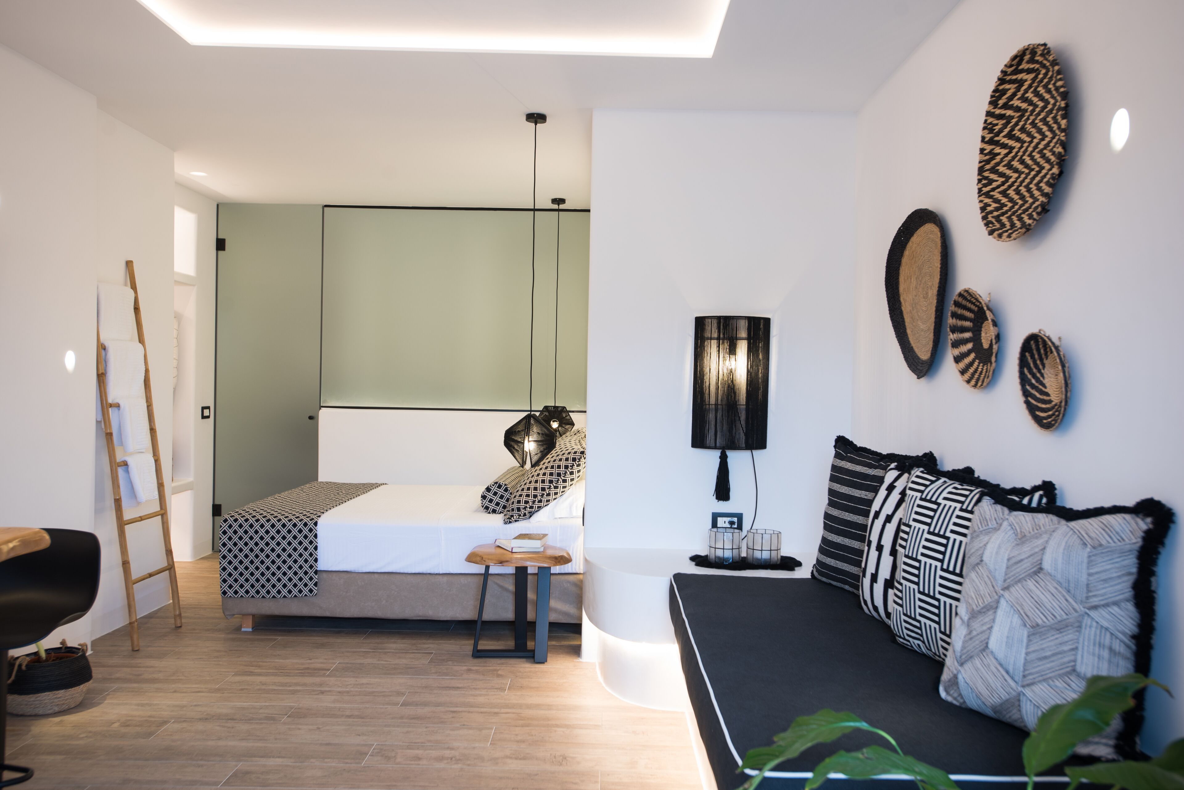 A modern bedroom with a bed, bedside table, and a desk.