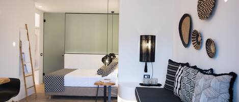 A modern bedroom with a bed, bedside table, and a desk.