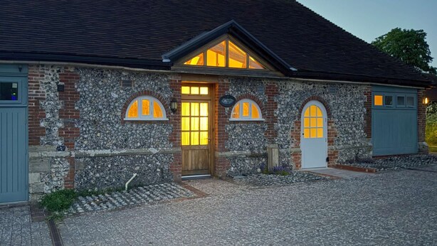A building with a stone facade, a wooden door, and arched windows. - Within the South Downs National Park, 7 miles north of Brighton. (Hassocks)