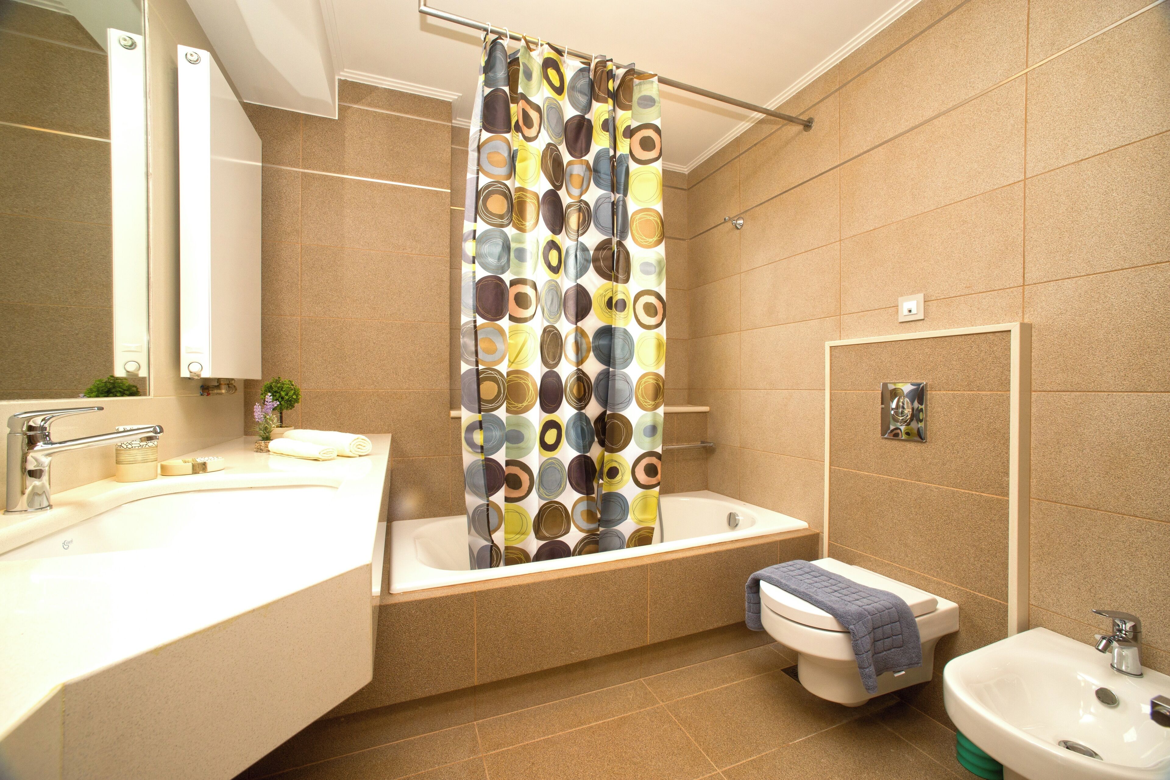 A modern bathroom with a bathtub, a sink, and a toilet.