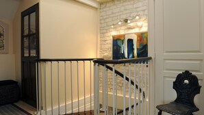 A staircase with a white railing, a stone wall, and a bench. - La Salle de Danse - Eaux Puiseaux (EAUX PUISEAUX)