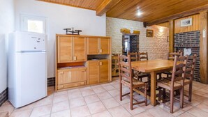 Una cocina pequeña con armarios de madera, una mesa de comedor y sillas.