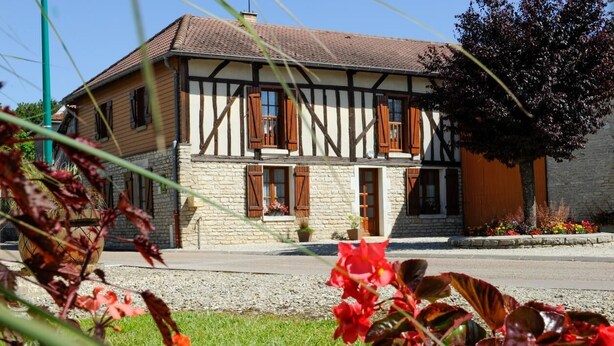 A two-story building with a stone facade and timber framing.