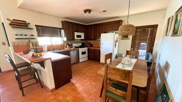 Fridge, microwave, coffee/tea maker, cookware/dishes/utensils