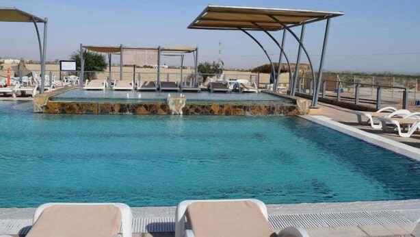 A swimming pool with lounge chairs and a covered area. - Casa Roja, a spacious 3-bedroom home (San Felipe)