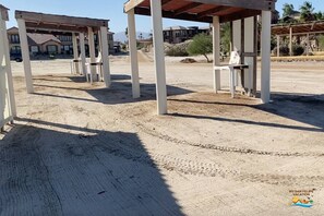 A sandy outdoor area with white structures, possibly a resort or hotel, with no visible amenities or specific features. - Condo 9-2 Resort Rental with pool access (San Felípe)