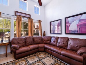 A brown leather sectional sofa, a patterned rug, a framed quote, and two framed artworks on the wall. - Condo 9-2 Resort Rental with pool access (San Felípe)